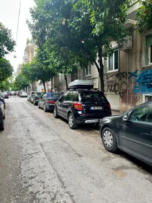 a row of cars parked on the side of a street at Mr Negri in Athens