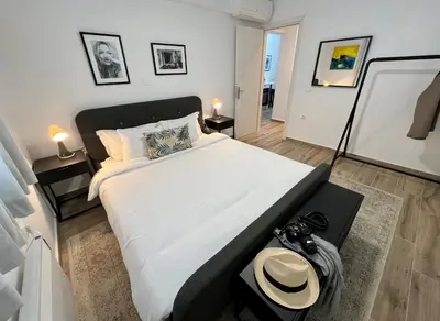 a bedroom with a large bed with a hat on it at Mr Negri in Athens