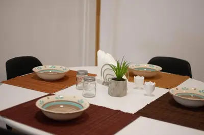 a table with plates and bowls on top of it at Garden of Eden in Neos Kosmos in Athens