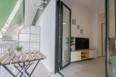 a living room with a bench and a tv at Garden of Eden in Neos Kosmos in Athens