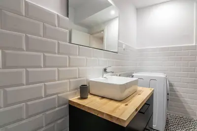 a bathroom with a sink and a white brick wall at Garden of Eden in Neos Kosmos in Athens
