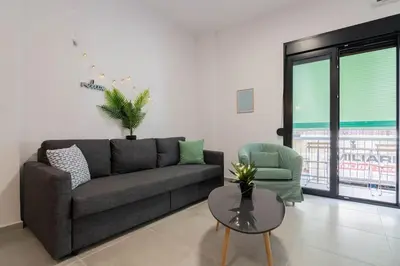 a living room with a couch and a table at Garden of Eden in Neos Kosmos in Athens