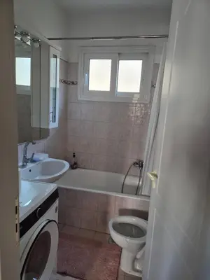 a bathroom with a tub and a toilet and a sink at Airport city center 3 in Spáta