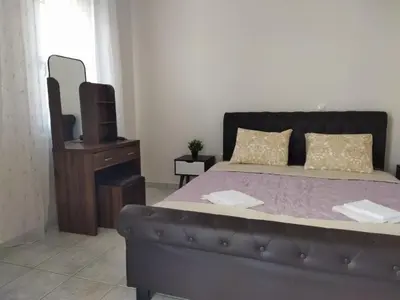 a bedroom with a bed with a couch and a tv at Airport city center 3 in Spáta
