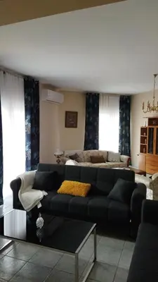 a living room with a couch and a bed at Airport city center 3 in Spáta