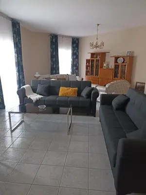 a living room with a couch and a table at Airport city center 3 in Spáta
