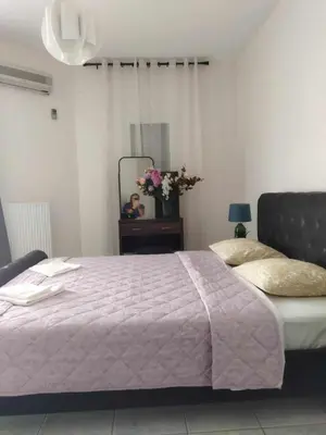 a bedroom with a large bed and a mirror at Airport city center 3 in Spáta
