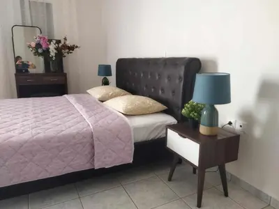 a bedroom with a bed and a table with a lamp at Airport city center 3 in Spáta