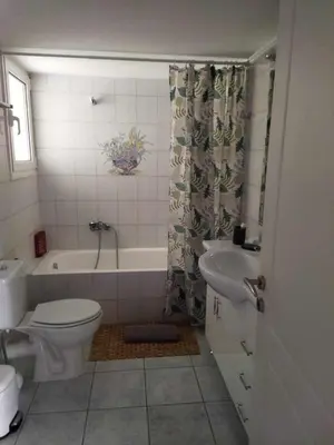 a bathroom with a toilet and a tub and a sink at Airport city center 3 in Spáta
