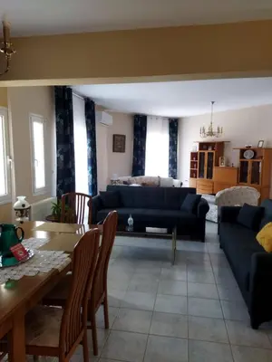 a living room with a couch and a table at Airport city center 3 in Spáta