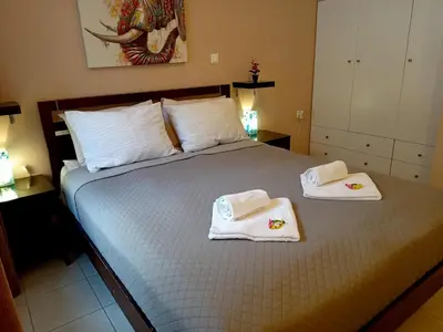 a bedroom with a bed with towels on it at Myilios by Ilios Company in Athens
