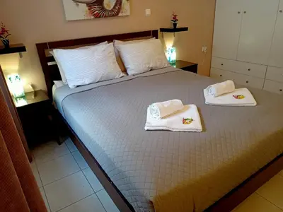 a bedroom with a bed with towels on it at Myilios by Ilios Company in Athens
