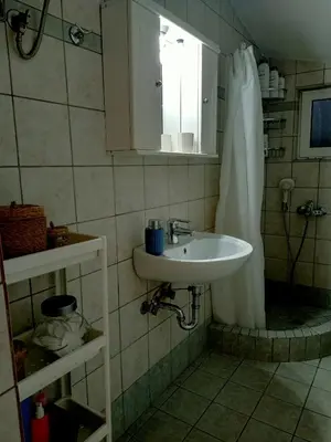 a bathroom with a sink and a shower curtain at Myilios by Ilios Company in Athens