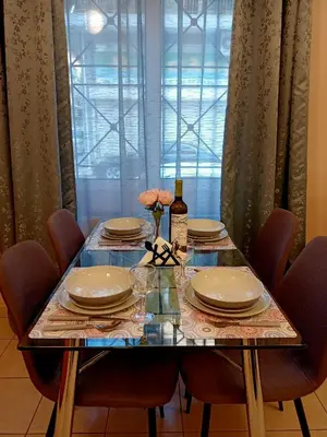 a dining room table with chairs and plates and flowers on it at Myilios by Ilios Company in Athens
