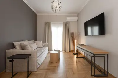 a living room with a couch and a table at Like Home Acropolis 50 in Athens