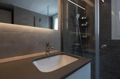 a bathroom with a sink and a shower at Like Home Acropolis 50 in Athens