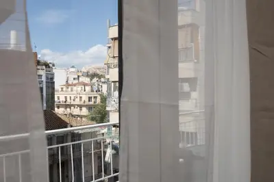 a window with a view of a city at Like Home Acropolis 50 in Athens