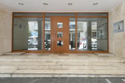 an entrance to a building with glass doors at Like Home Acropolis 50 in Athens