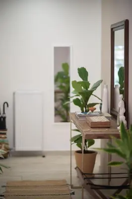 a room with a table with plants and a mirror at 1BR Athenian Serenity 15 Minutes From Acropolis in Athens