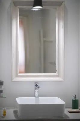 a bathroom with a white sink and a mirror at 1BR Athenian Serenity 15 Minutes From Acropolis in Athens