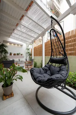 a swing chair on an outdoor patio at 1BR Athenian Serenity 15 Minutes From Acropolis in Athens