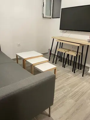 a living room with a couch and a large tv at Pagrati Green Studio in Athens