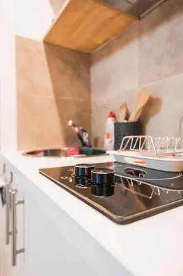 a kitchen counter with a stove top in a kitchen at Technopolis Luxury Apartments in Athens