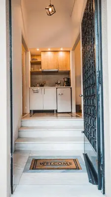 an open door leading to a kitchen with a kitchenasteryasteryasteryasteryasteryastery at Technopolis Luxury Apartments in Athens