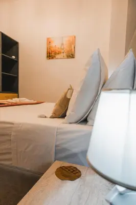 a bedroom with a bed with pillows on it at Technopolis Luxury Apartments in Athens