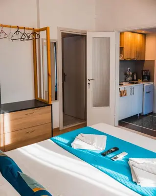 a bedroom with a large bed with a tv on it at Technopolis Luxury Apartments in Athens