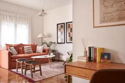 a living room with a couch and a table at Sunny and Comfy Apartment in kolonaki in Athens