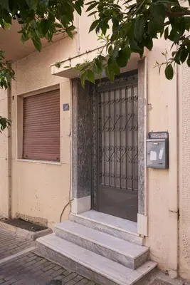 a door of a building with stairs leading to it at Sunny and Comfy Apartment in kolonaki in Athens