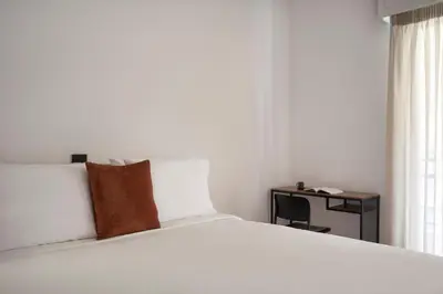 a bedroom with a large white bed and a desk at Bright Apt-Archeological Museum in Athens