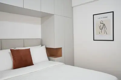 a bedroom with a bed with a picture on the wall at Bright Apt-Archeological Museum in Athens