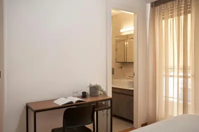 a bedroom with a desk with a chair and a mirror at Bright Apt-Archeological Museum in Athens
