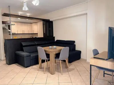 a living room with a table and a couch at 2BR Apartment next to National Archaeological Museum and AUEB in Athens