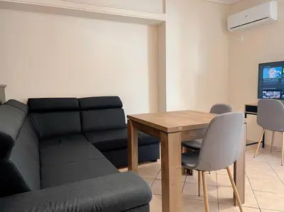a living room with a couch and a table at 2BR Apartment next to National Archaeological Museum and AUEB in Athens