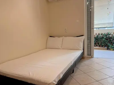 a white bed in a room with a window at 2BR Apartment next to National Archaeological Museum and AUEB in Athens