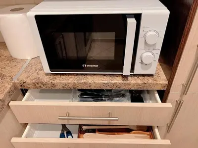 a microwave oven sitting on top of a kitchen counter at 2BR Apartment next to National Archaeological Museum and AUEB in Athens