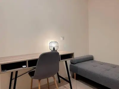 a desk with a chair and a couch in a room at 2BR Apartment next to National Archaeological Museum and AUEB in Athens