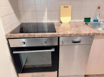 a small kitchen with a stove and a sink at 2BR Apartment next to National Archaeological Museum and AUEB in Athens