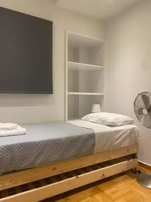 a bedroom with a bed and a tv on the wall at Apartment in Fancy Athenian Neighbourhood in Athens