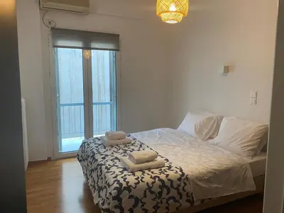 a bedroom with a bed with two towels on it at Apartment in Fancy Athenian Neighbourhood in Athens