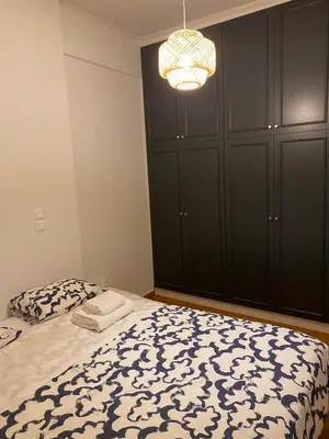 a bedroom with a bed and a chandelier at Apartment in Fancy Athenian Neighbourhood in Athens