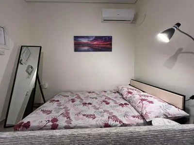 a bedroom with a bed with a pink bedspread at Cozy Apartment In The Heart Of Athens in Athens