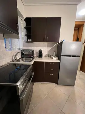a kitchen with a stainless steel refrigerator and a sink at Cozy Apartment In The Heart Of Athens in Athens