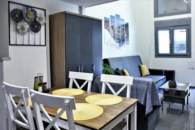 a dining room and living room with a table and chairs at Dimosthenis_loft2 in Athens