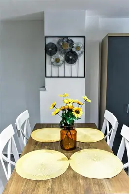 a dining room table with two plates and a vase of flowers at Dimosthenis_loft2 in Athens