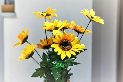 a bunch of yellow flowers in a vase at Dimosthenis_loft2 in Athens