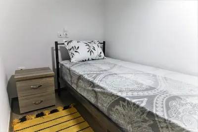 a small bedroom with a bed and a dresser at Dimosthenis_loft2 in Athens